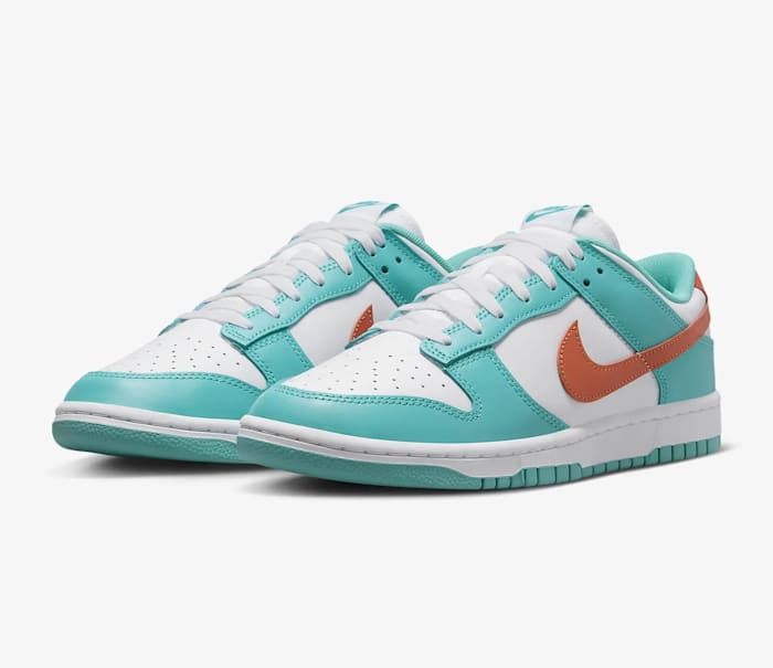 Side view of teal, white, and orange Nike Dunk sneakers.